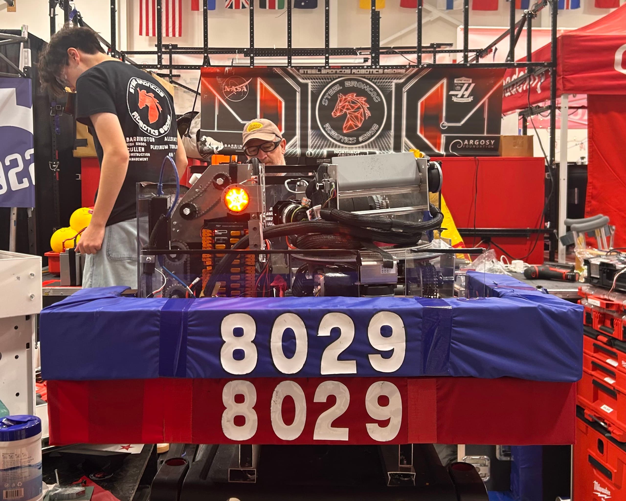 The robot in the pit in front of the team's sponsor banner