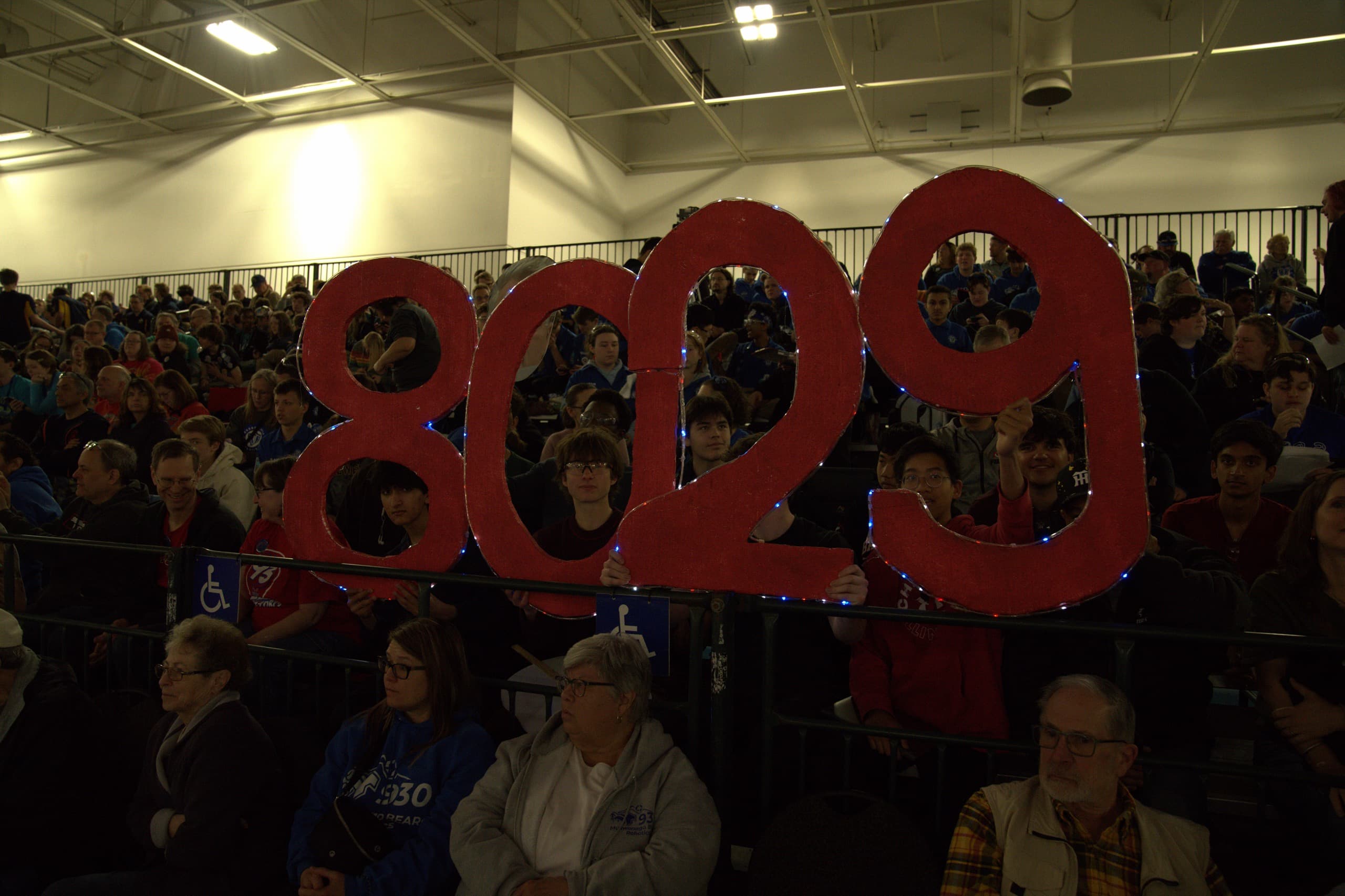 Supporters in the competition stands holding a large red 8029 sign